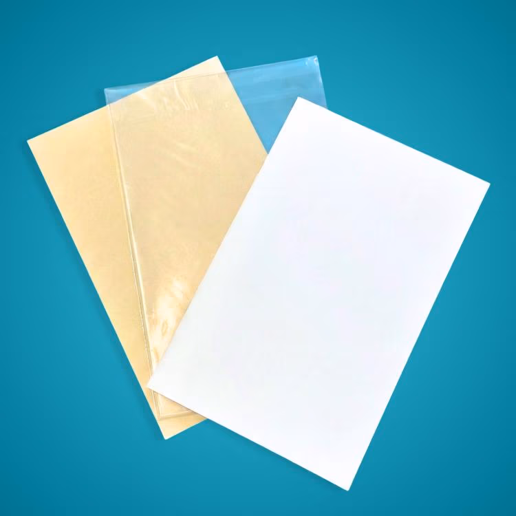 White sheet on top of a beige folder and a translucent plastic sleeve against a teal background.