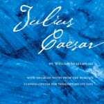 Blue textured cover for julius caesar, updated edition from the folger shakespeare library, with white cursive title and author credit.